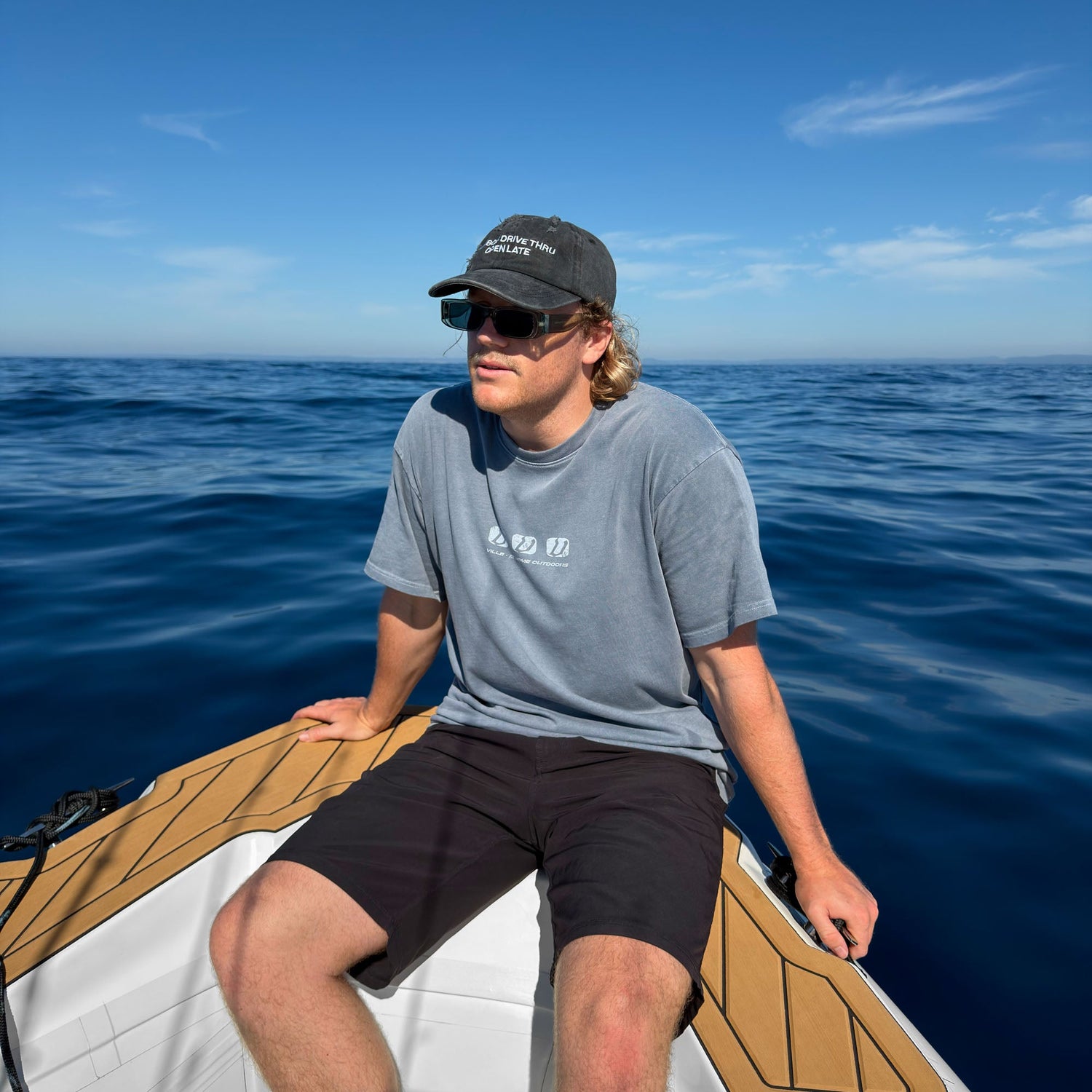Surfer wearing retro surf shirt on a boat